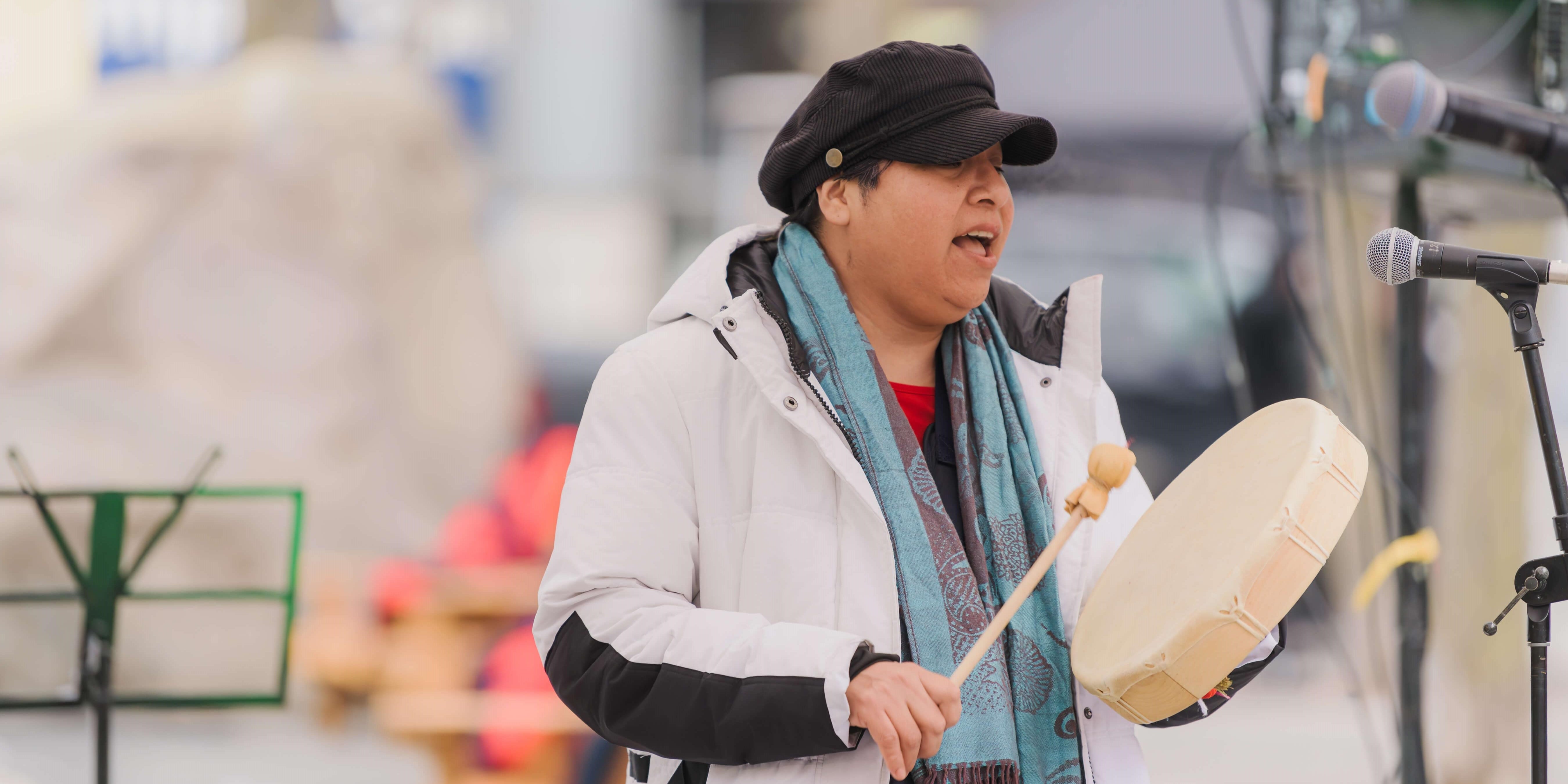 Amy Desjarlais playing the drums at the TMU Frost Holiday Market.